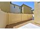The backyard features a small patio, rock landscaping, and a beige fence at 2747 Tahiti Grape Way # 2, Las Vegas, NV 89183