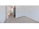 Neutral bedroom featuring carpet floors, built-in shelving unit, and access to other rooms at 2747 Tahiti Grape Way # 2, Las Vegas, NV 89183