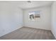Bright bedroom featuring neutral carpet, white walls, and a window with a neighborhood view at 2747 Tahiti Grape Way # 2, Las Vegas, NV 89183