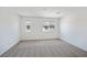 Bright bedroom featuring neutral carpet, white walls, and natural light from two windows at 2747 Tahiti Grape Way # 2, Las Vegas, NV 89183
