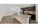Open kitchen featuring a granite island with seating, stainless steel appliances, and dark wood cabinetry at 2747 Tahiti Grape Way # 2, Las Vegas, NV 89183