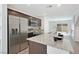Spacious kitchen with granite counters, stainless steel appliances, dark wood cabinets, and an open layout at 2747 Tahiti Grape Way # 2, Las Vegas, NV 89183