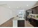 Contemporary kitchen showcasing a granite island with bar seating, stainless steel appliances and dark wood cabinets at 2747 Tahiti Grape Way # 2, Las Vegas, NV 89183