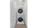 A stacked washer and dryer sit against the wall in the laundry room at 2747 Tahiti Grape Way # 2, Las Vegas, NV 89183