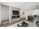 Open-concept living area with a fireplace, TV, and kitchen island, perfect for modern living at 2747 Tahiti Grape Way # 2, Las Vegas, NV 89183