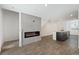 Open-concept living area with fireplace, wood-look floors, and a view of the kitchen at 2747 Tahiti Grape Way # 2, Las Vegas, NV 89183