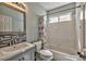 Bathroom features a shower-tub combo, modern vanity, mosaic backsplash and neutral walls at 3525 Dover Bay St, Las Vegas, NV 89129
