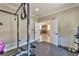 Home gym area with workout equipment and a view through double doors to the living area at 3525 Dover Bay St, Las Vegas, NV 89129