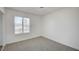 Bedroom with a window and neutral carpeting, freshly painted white walls at 4047 Maple Hill Rd, Las Vegas, NV 89115