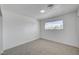 Bright bedroom featuring neutral carpet, a large window, and fresh paint, offering a serene and comfortable space at 4047 Maple Hill Rd, Las Vegas, NV 89115