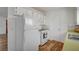 Charming kitchen with white appliances, wooden floors, shaker style cabinets, and mosaic backsplash offers a bright functional area at 4047 Maple Hill Rd, Las Vegas, NV 89115