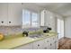 Stylish kitchen with shaker cabinets, mosaic backsplash, undermount sink and wood flooring, providing a modern and functional space at 4047 Maple Hill Rd, Las Vegas, NV 89115