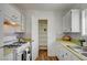 The kitchen featuring white cabinets, mosaic backsplash, and wood flooring, creates a bright space perfect for cooking at 4047 Maple Hill Rd, Las Vegas, NV 89115
