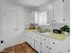 The kitchen features shaker style cabinets, mosaic backsplash, and wood flooring, creating a stylish and inviting space at 4047 Maple Hill Rd, Las Vegas, NV 89115