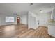 An inviting open-concept living space with wood-look flooring and a well-lit kitchen at 4047 Maple Hill Rd, Las Vegas, NV 89115