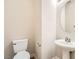 Neat half-bath featuring a pedestal sink, toilet, and modern fixtures at 4118 Beech Family St, Las Vegas, NV 89115