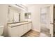 Bathroom featuring dual sinks, a large mirror, and a view into an adjoining room at 4118 Beech Family St, Las Vegas, NV 89115