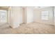 Spacious bedroom featuring neutral carpet, bright natural light from a large window, and multiple entryways at 4118 Beech Family St, Las Vegas, NV 89115