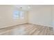 Bright bedroom with wood-look flooring, a ceiling fan, and large windows at 4118 Beech Family St, Las Vegas, NV 89115