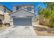 Charming two-story home with a neutral color palette, a gray garage door, and well-kept landscaping at 4118 Beech Family St, Las Vegas, NV 89115