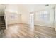Expansive living room with wood-look flooring, a ceiling fan, and abundant natural light at 4118 Beech Family St, Las Vegas, NV 89115
