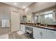 This bathroom features double sinks, an extended countertop, vanity, and lots of storage at 4336 Guava Ct # 0, Las Vegas, NV 89135