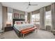 This bedroom features a ceiling fan, area rug, bench, natural light, and modern decor at 4336 Guava Ct # 0, Las Vegas, NV 89135