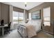 This bedroom is well-lit and features an area rug, ceiling fan, and computer desk at 4336 Guava Ct # 0, Las Vegas, NV 89135