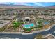 Aerial view of an upscale community pool with manicured landscaping and amenities, surrounded by modern homes at 4336 Guava Ct # 0, Las Vegas, NV 89135