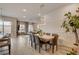 Open-concept dining area with a modern table, leading to a living space and a stylish kitchen at 4336 Guava Ct # 0, Las Vegas, NV 89135