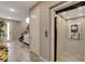 Hallway featuring a convenient in-home elevator with stylish tile flooring and modern interior at 4336 Guava Ct # 0, Las Vegas, NV 89135