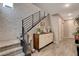 Inviting foyer features textured accent wall, modern railing, stylish cabinet, and wood-look tile flooring at 4336 Guava Ct # 0, Las Vegas, NV 89135