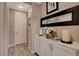Hallway with stylish white cabinets, a decorative mirror, and accent lighting at 4336 Guava Ct # 0, Las Vegas, NV 89135
