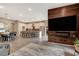 Open-concept living area featuring wood-paneled wall with large TV, modern lighting, and spacious kitchen and dining areas at 4336 Guava Ct # 0, Las Vegas, NV 89135