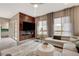 Stylish living room featuring a wood accent wall, large windows, and comfortable seating at 4336 Guava Ct # 0, Las Vegas, NV 89135
