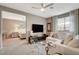 Inviting living space with a comfortable white sectional, a large tv, and adjacent bedroom at 4336 Guava Ct # 0, Las Vegas, NV 89135