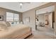Bright main bedroom showcasing a queen-sized bed, ceiling fan, and open access to the living room at 4336 Guava Ct # 0, Las Vegas, NV 89135