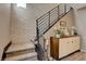 Modern staircase with a textured wall and decorative cabinet with a white Buddha statue at 4336 Guava Ct # 0, Las Vegas, NV 89135