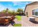 Private backyard featuring a brick patio, lawn, mature trees, and shed; ideal for outdoor living at 4508 Dragon Fly Creek Ave, North Las Vegas, NV 89031