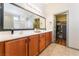 Elegant bathroom features double sinks, a large mirror, and ample cabinet space with walk-in closet at 4508 Dragon Fly Creek Ave, North Las Vegas, NV 89031