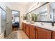 Bright bathroom features double sinks, a large mirror, and a shower with glass door, and adjoins main bedroom at 4508 Dragon Fly Creek Ave, North Las Vegas, NV 89031
