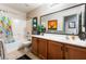 Bathroom features a white tub, shower, vanity and ship artwork at 4508 Dragon Fly Creek Ave, North Las Vegas, NV 89031