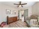 Bedroom with animal art, dresser, crib, and area rug at 4508 Dragon Fly Creek Ave, North Las Vegas, NV 89031