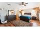 Spacious bedroom featuring hardwood floors, a ceiling fan, and bright windows at 4508 Dragon Fly Creek Ave, North Las Vegas, NV 89031