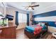 Childs bedroom with ceiling fan, wood-look floors, and unique blue wall design at 4508 Dragon Fly Creek Ave, North Las Vegas, NV 89031