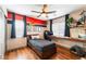 A bedroom with wood floors, a ceiling fan, and desk area at 4508 Dragon Fly Creek Ave, North Las Vegas, NV 89031