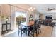 Bright dining room with large sliding glass doors, modern chandelier and tile floors at 4508 Dragon Fly Creek Ave, North Las Vegas, NV 89031