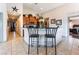 Open-concept kitchen featuring tile floors, a breakfast bar with seating, and ample cabinet space at 4508 Dragon Fly Creek Ave, North Las Vegas, NV 89031