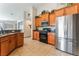 Charming kitchen features stainless steel appliances, wooden cabinets, and tiled flooring at 4508 Dragon Fly Creek Ave, North Las Vegas, NV 89031