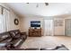 Comfortable living room with plush leather seating, decorative mirror, and neutral color palette at 4508 Dragon Fly Creek Ave, North Las Vegas, NV 89031